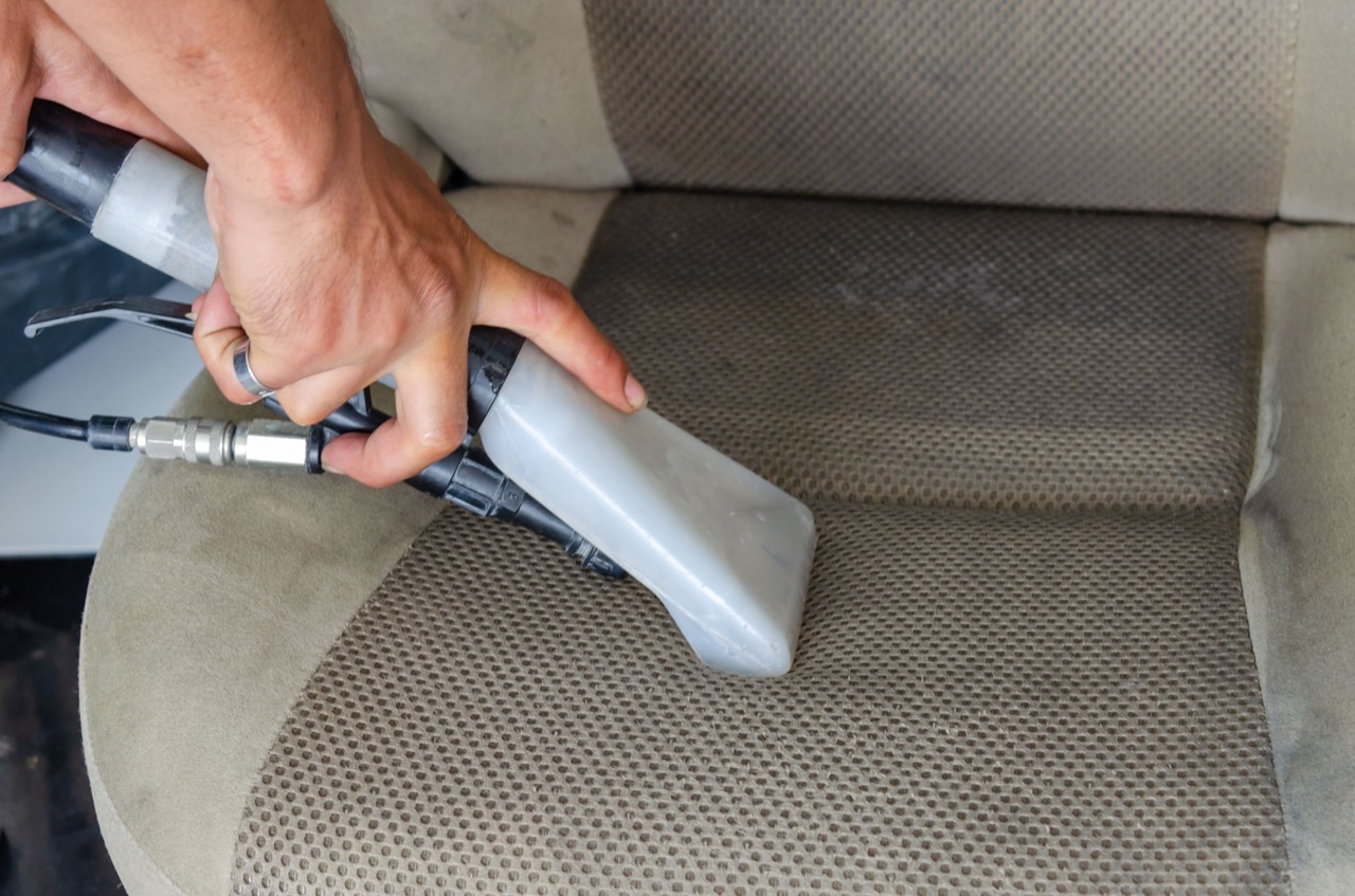 A car seat being shampooed and extracted